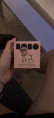 Frozen raspberries coated in chocolate